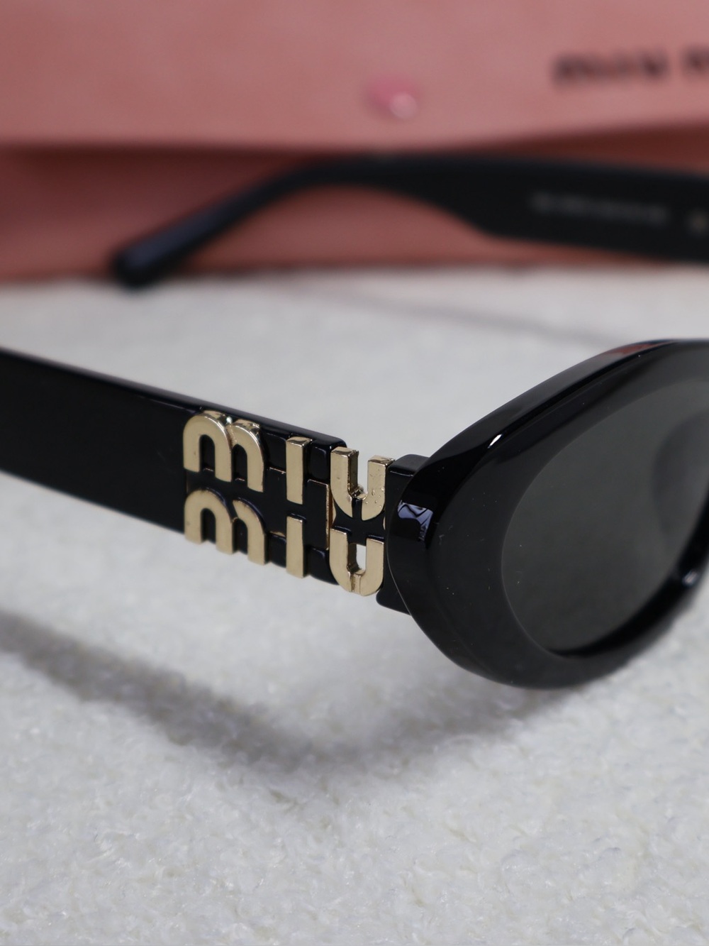 Miu Miu Black Sunglasses with Gold Logo Detail